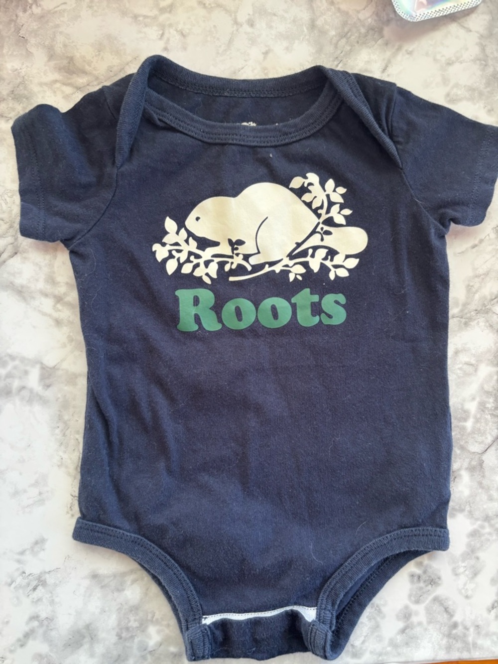 Roots Navy Blue Baby Onesie with White Beaver Graphic and Green Logo